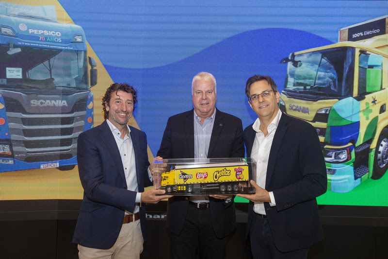 PepsiCo executives holding a toy version of PepsiCo electric truck