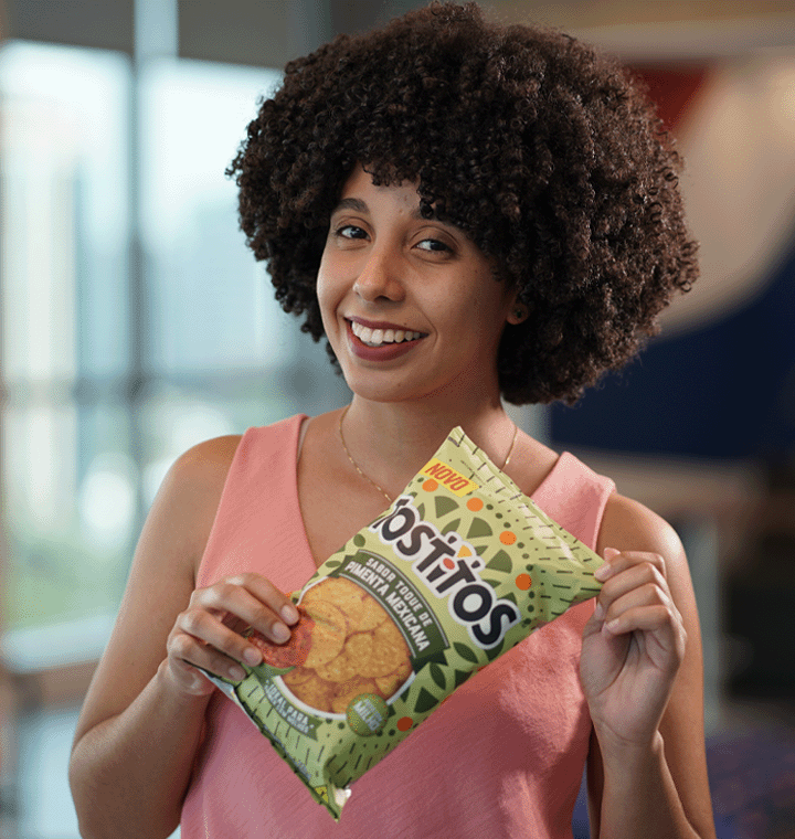 Employee holding bag of Tostitos