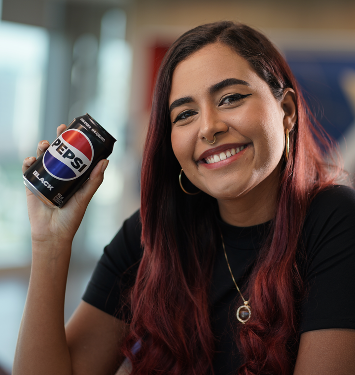 PepsiCo associate holding Pepsi can