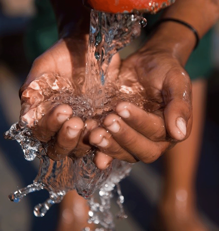 Hands cupping flowing water